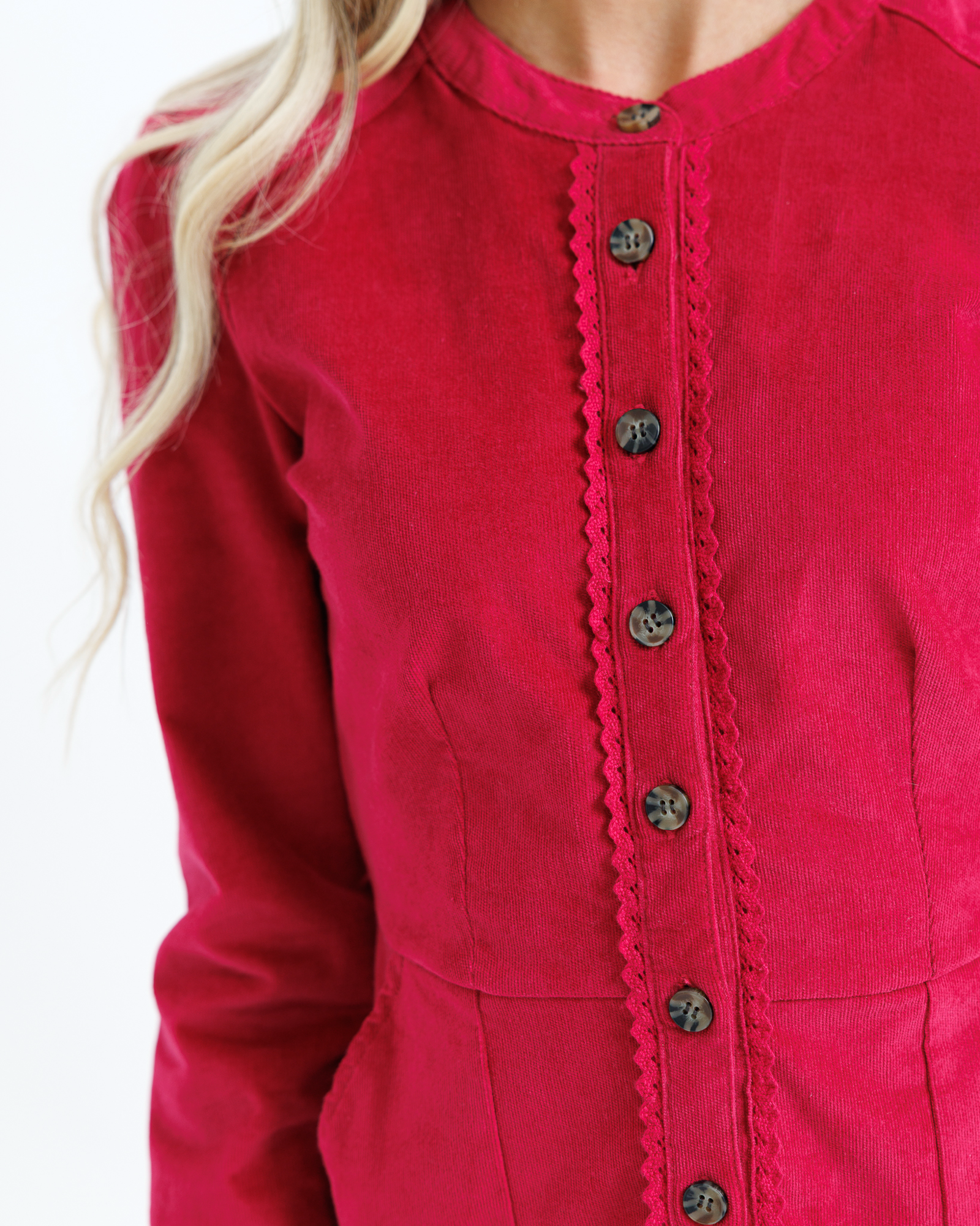 Close-up of a red button-up dress with a blurred background
