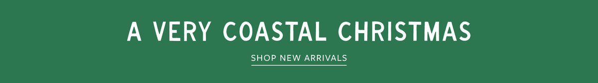 A green promotional banner with white text reading 'A VERY COASTAL CHRISTMAS' and smaller text below reading 'SHOP NEW ARRIVALS'.