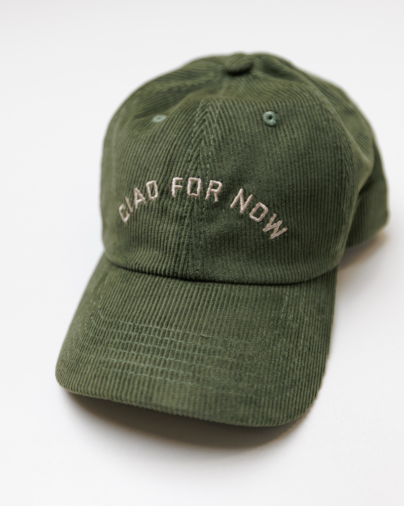 Green baseball cap with 'Ciao for Now' embroidered text on a white background
