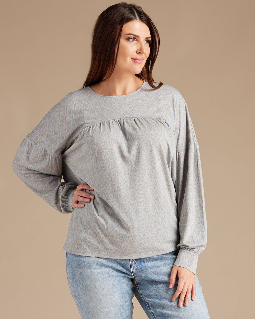 Woman in a gray long sleeve blouse