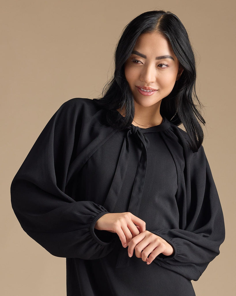 Woman in a black dress with removable sleeves