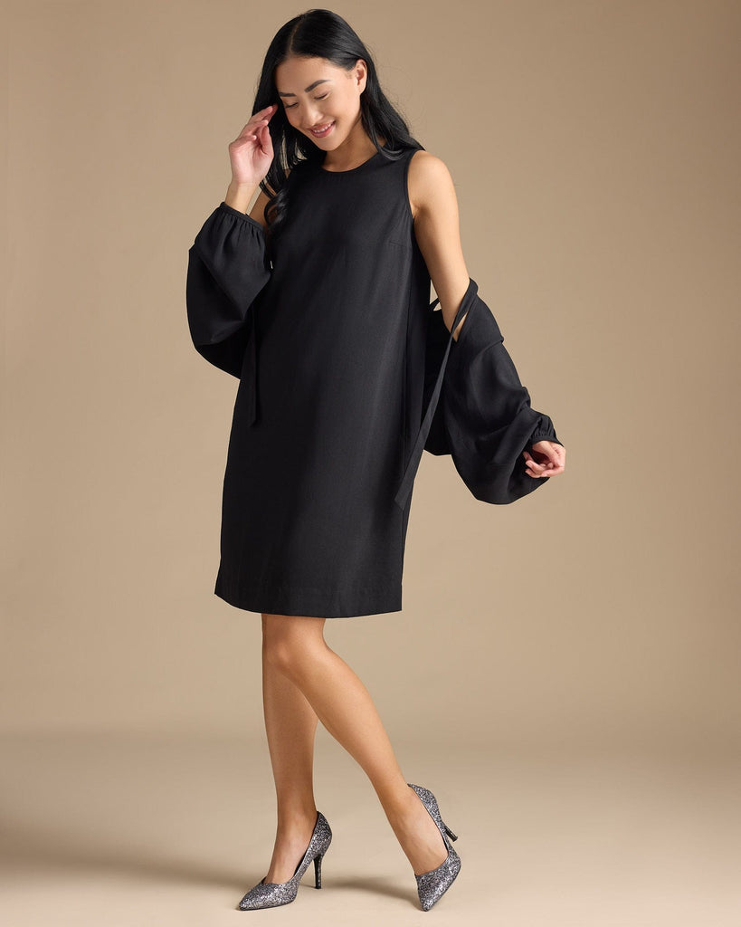 Woman in a black dress with removable sleeves