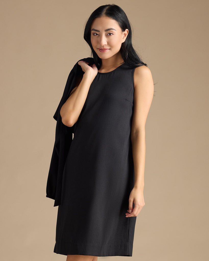 Woman in a black dress with removable sleeves