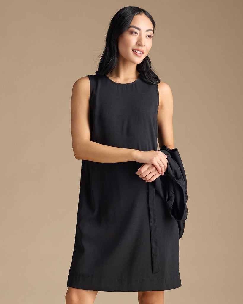 Woman in a black dress with removable sleeves