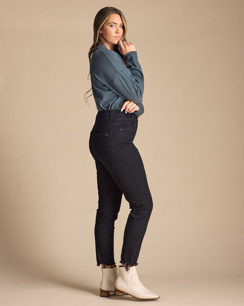 Woman in black high-rise skinny cropped jeans