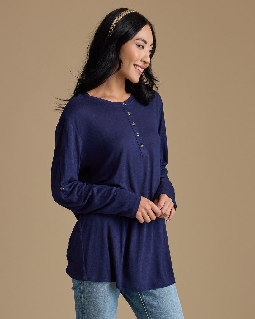 Woman in a navy, long sleeve, oversized, loose fitting blouse