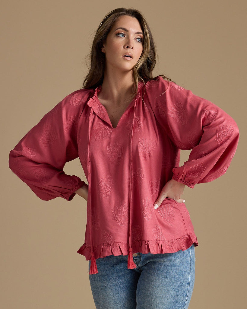 Woman in a pink long sleeve blouse