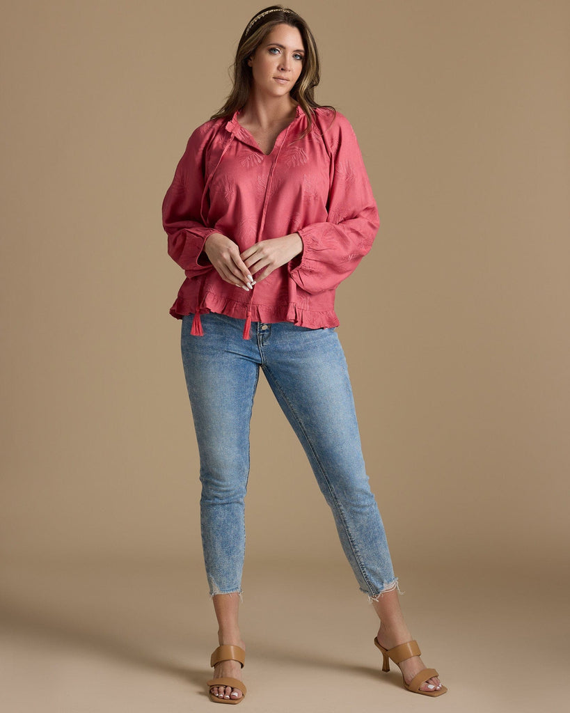 Woman in a pink long sleeve blouse