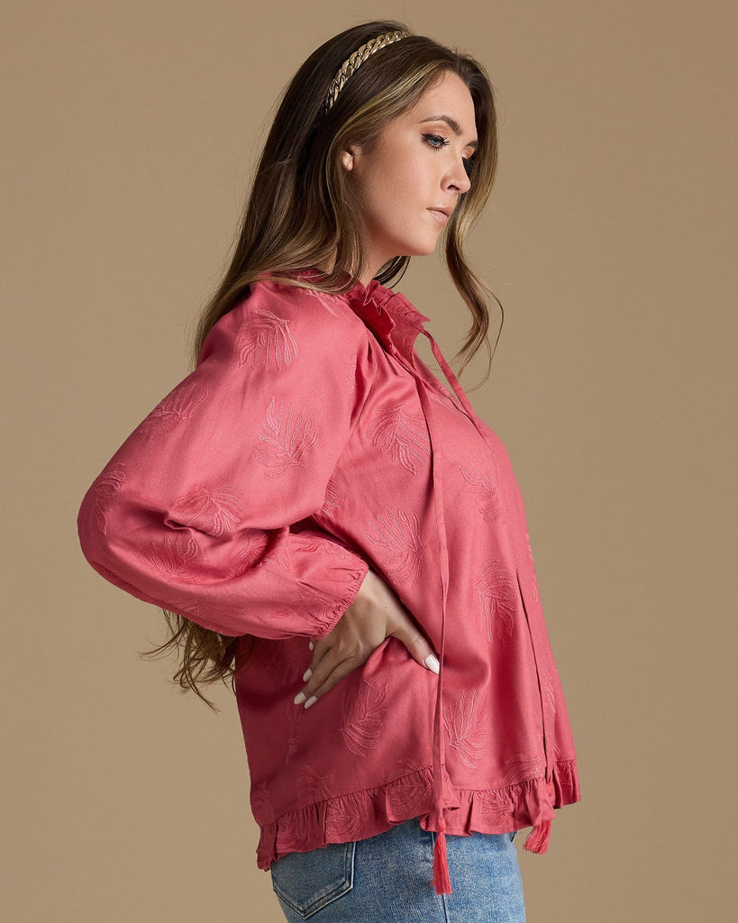 Woman in a pink long sleeve blouse