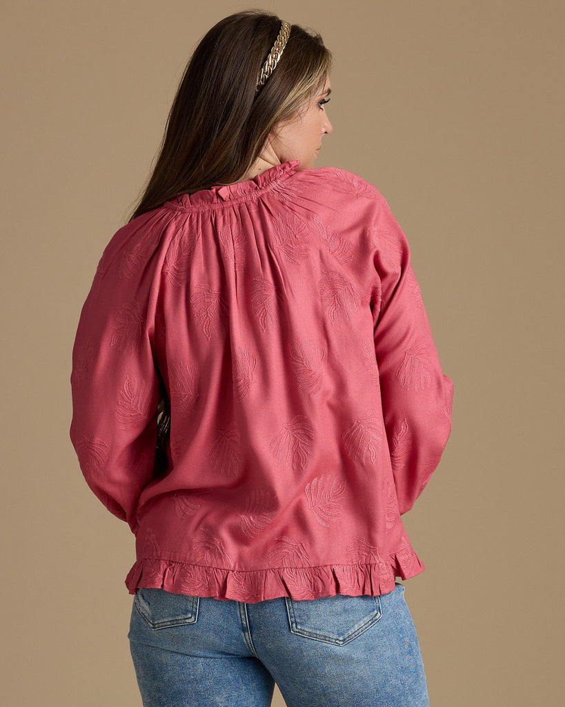 Woman in a pink long sleeve blouse