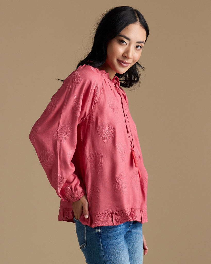 Woman in a pink long sleeve blouse