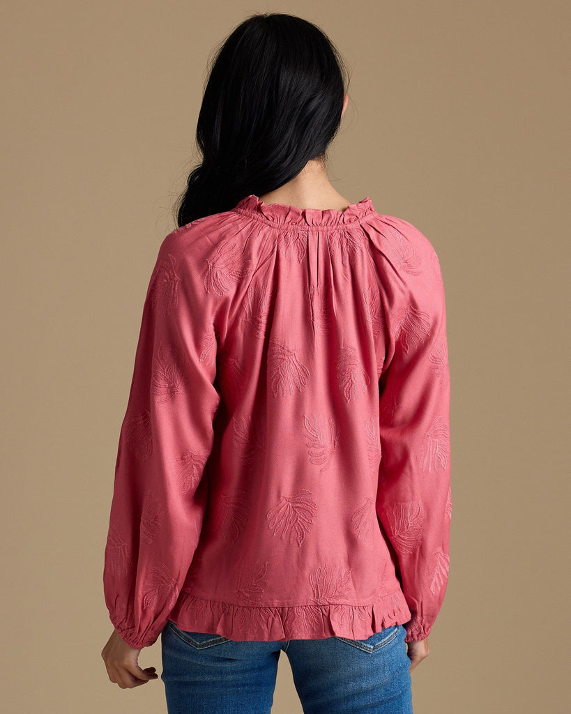 Woman in a pink long sleeve blouse