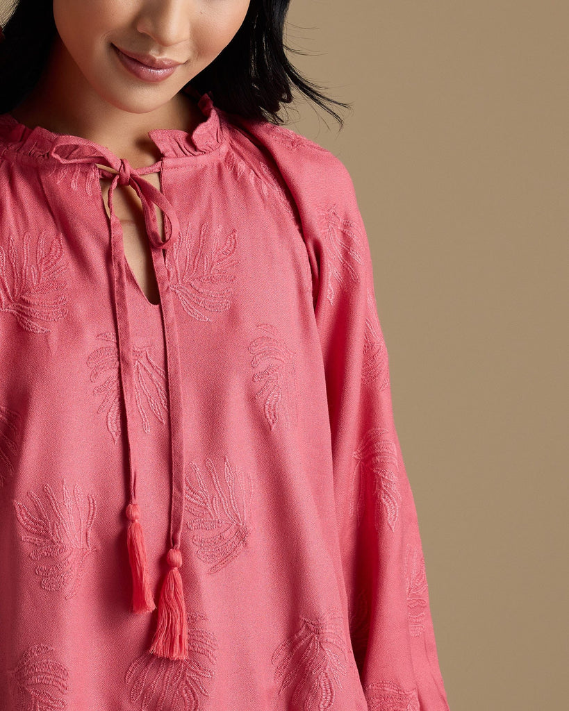 Woman in a pink long sleeve blouse