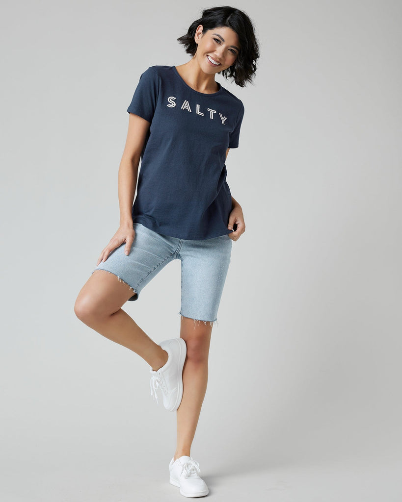 Woman in a navy graphic t-shirt with "SALTY" across the front