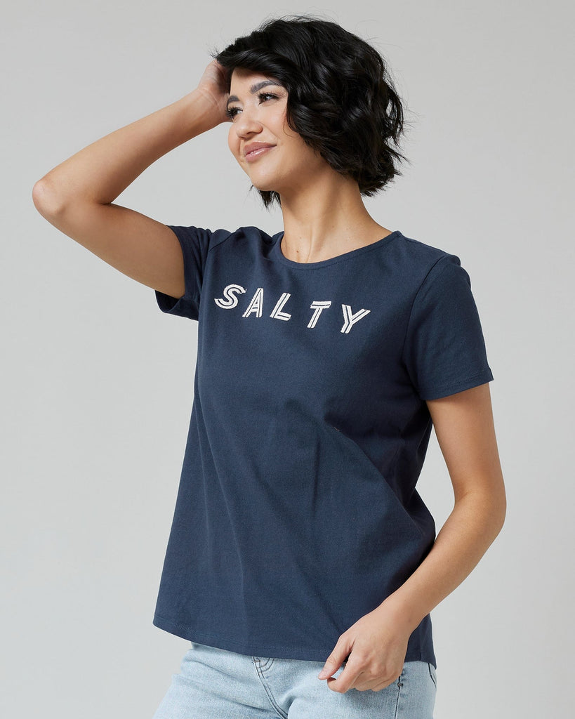 Woman in a navy graphic t-shirt with "SALTY" across the front