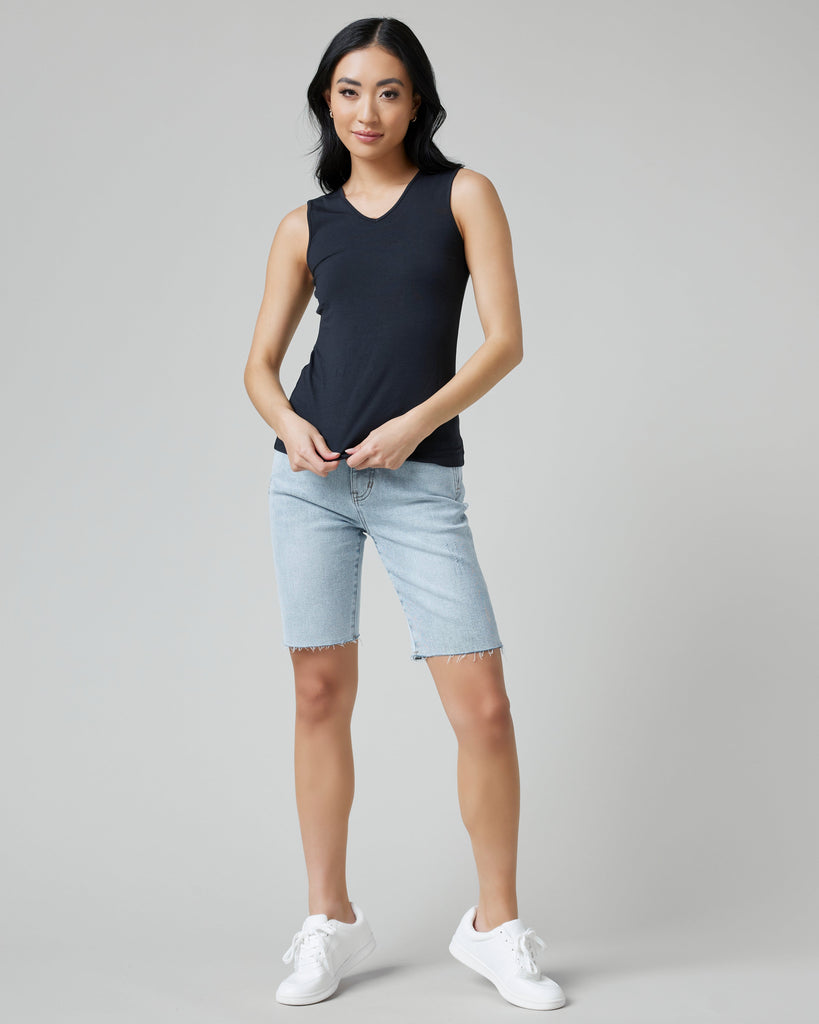 Woman in sleeveless, fitted, basic tank top