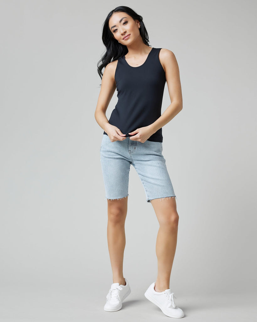 Woman in sleeveless, fitted, basic tank top