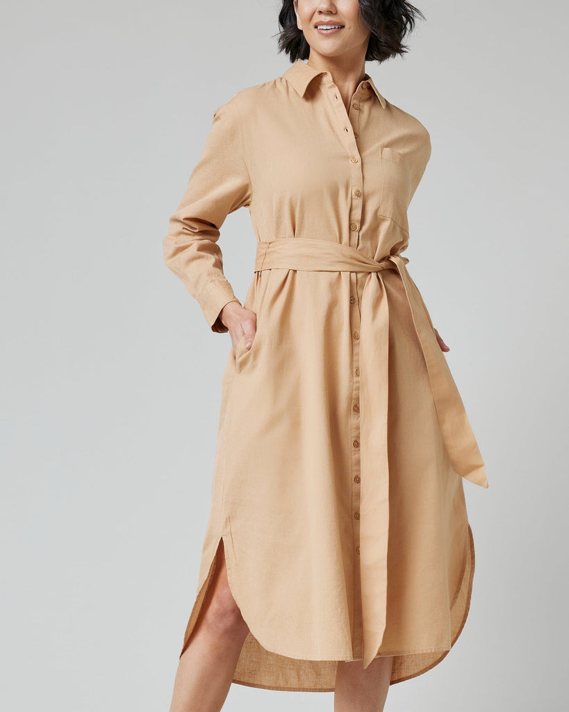 Woman in a long sleeve, knee-length, collared, button-down dress