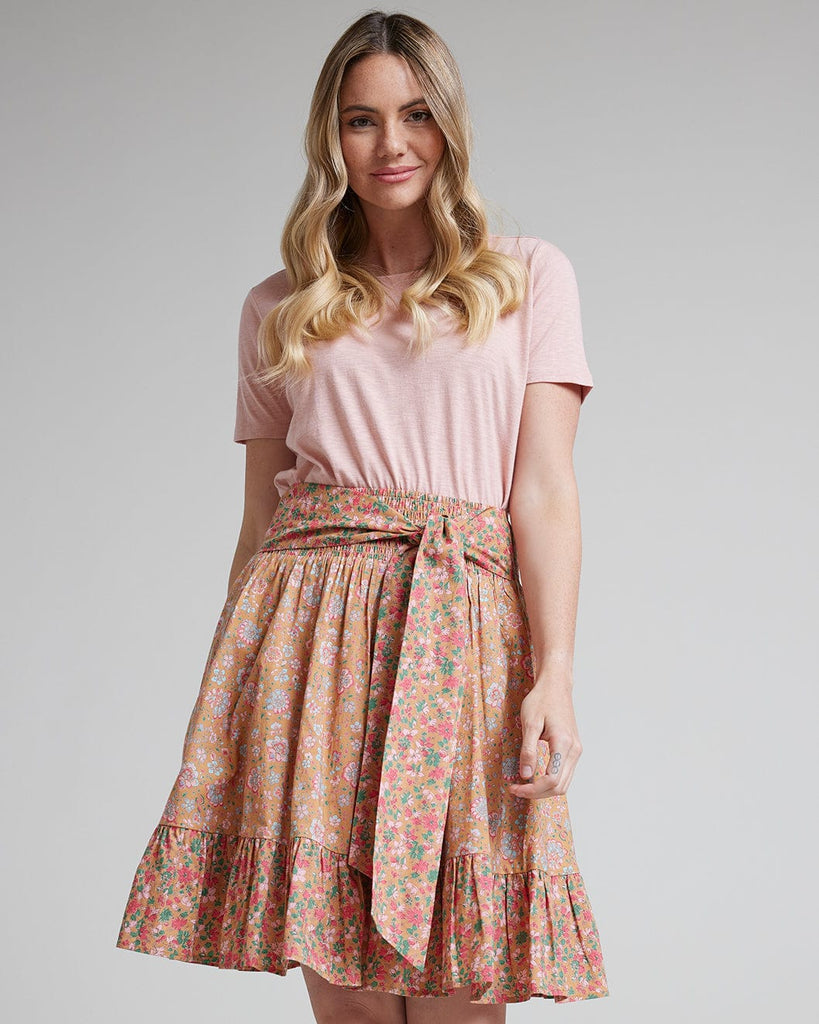 Woman in pink floral knee-length skirt