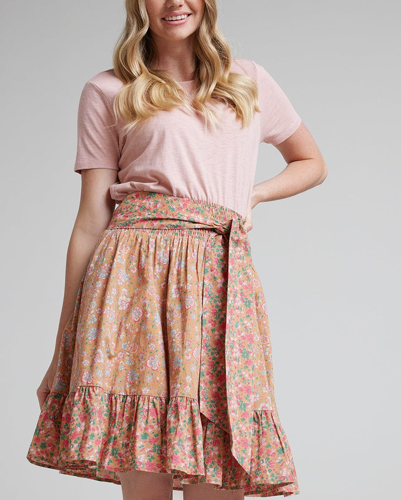 Woman in pink floral knee-length skirt