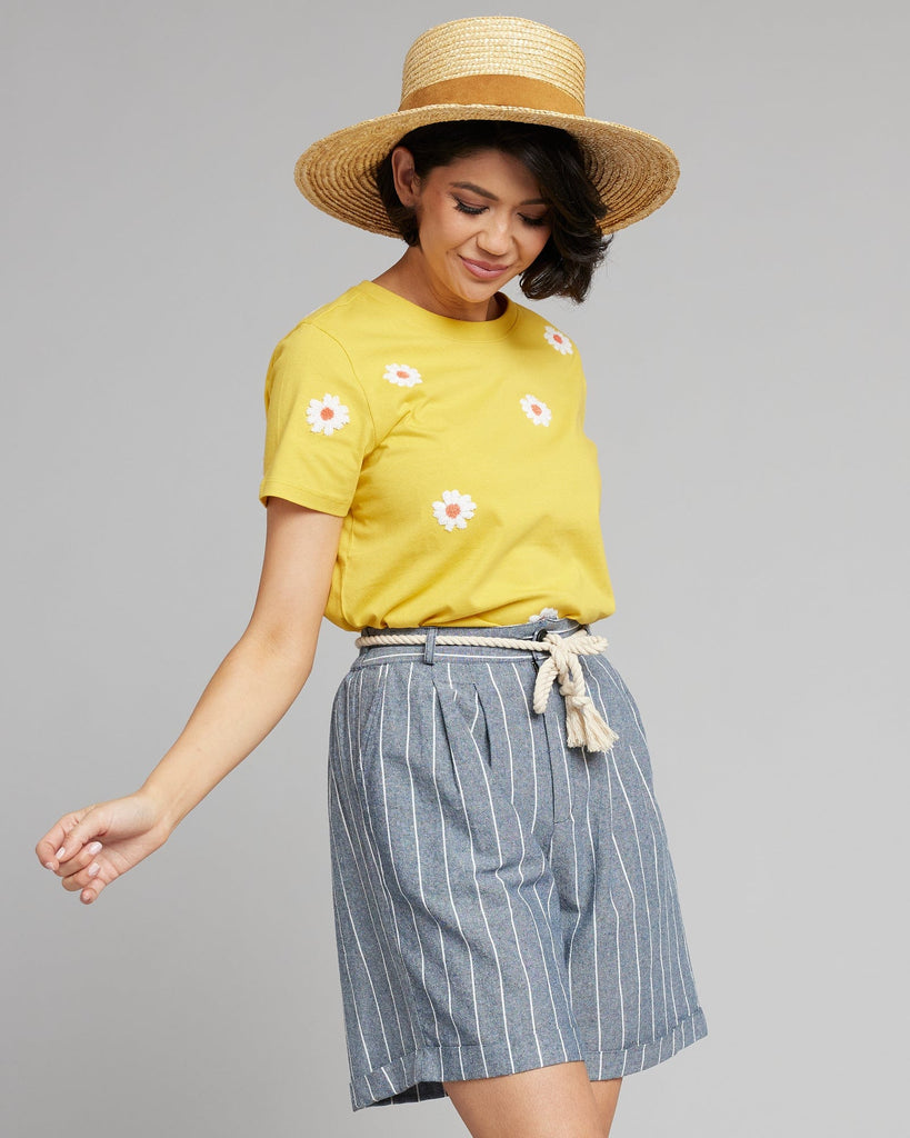 Woman in blue and white vertical striped shorts