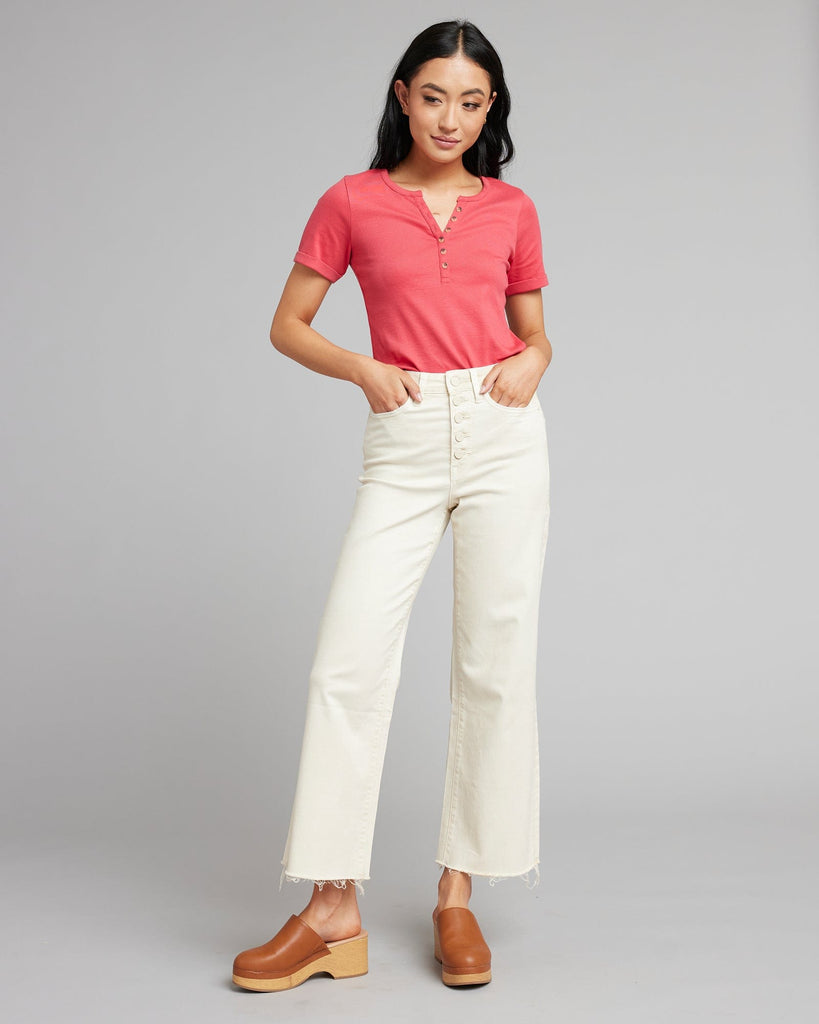 Woman in white high rise cropped denim pants.