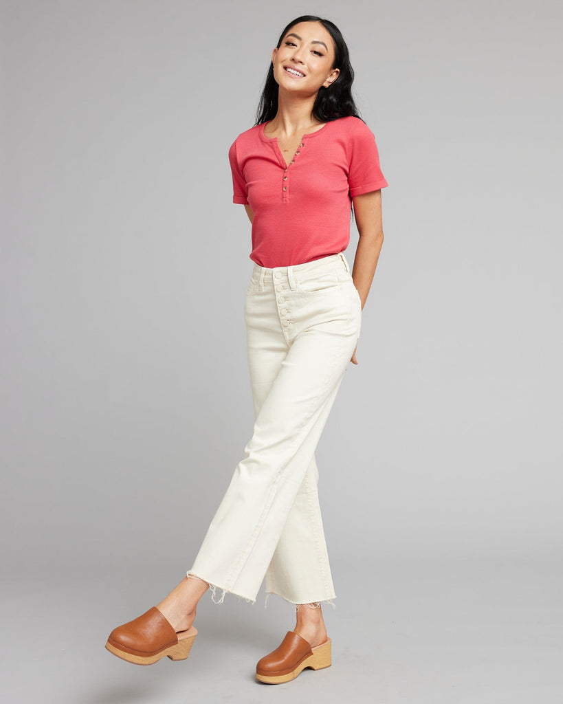 Woman in white high rise cropped denim pants.