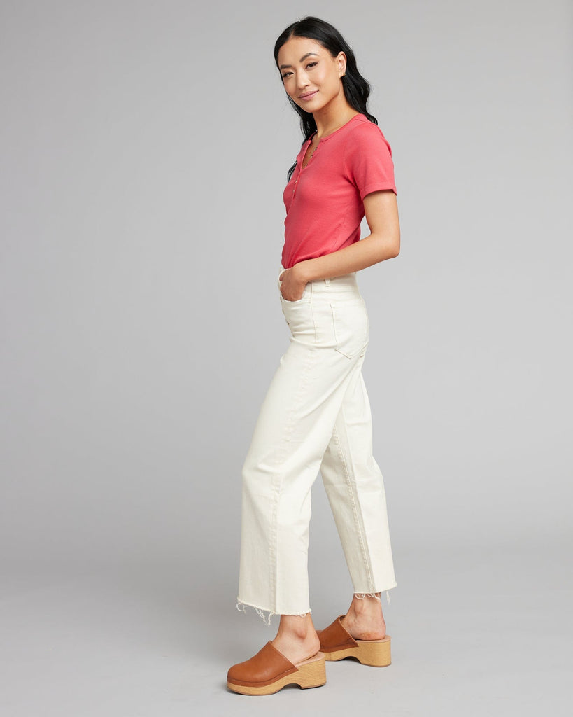 Woman in white high rise cropped denim pants.