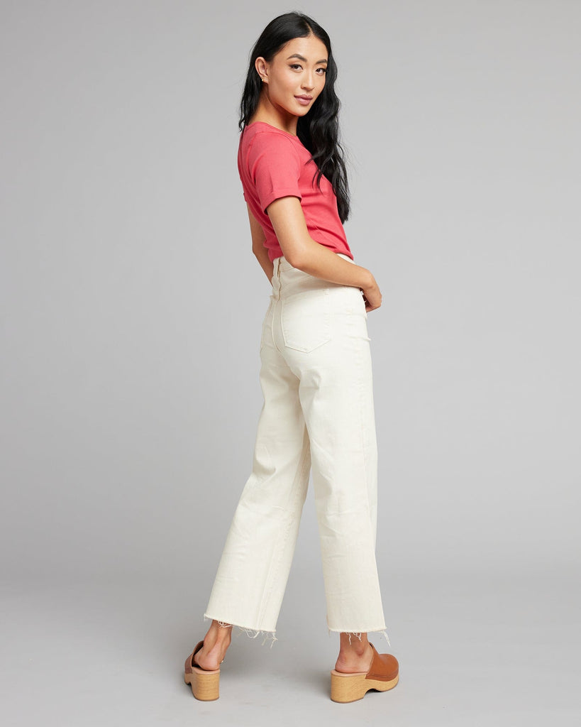 Woman in white high rise cropped denim pants.