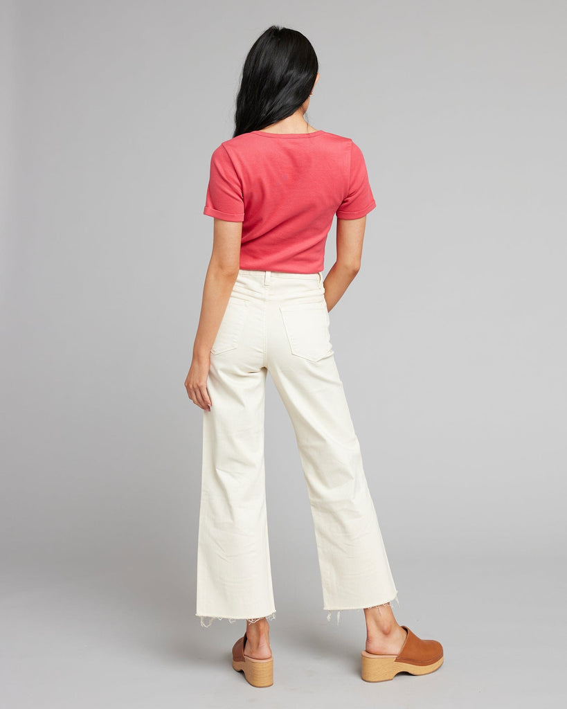 Woman in white high rise cropped denim pants.