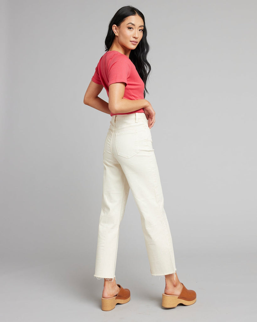 Woman in white high rise cropped denim pants.