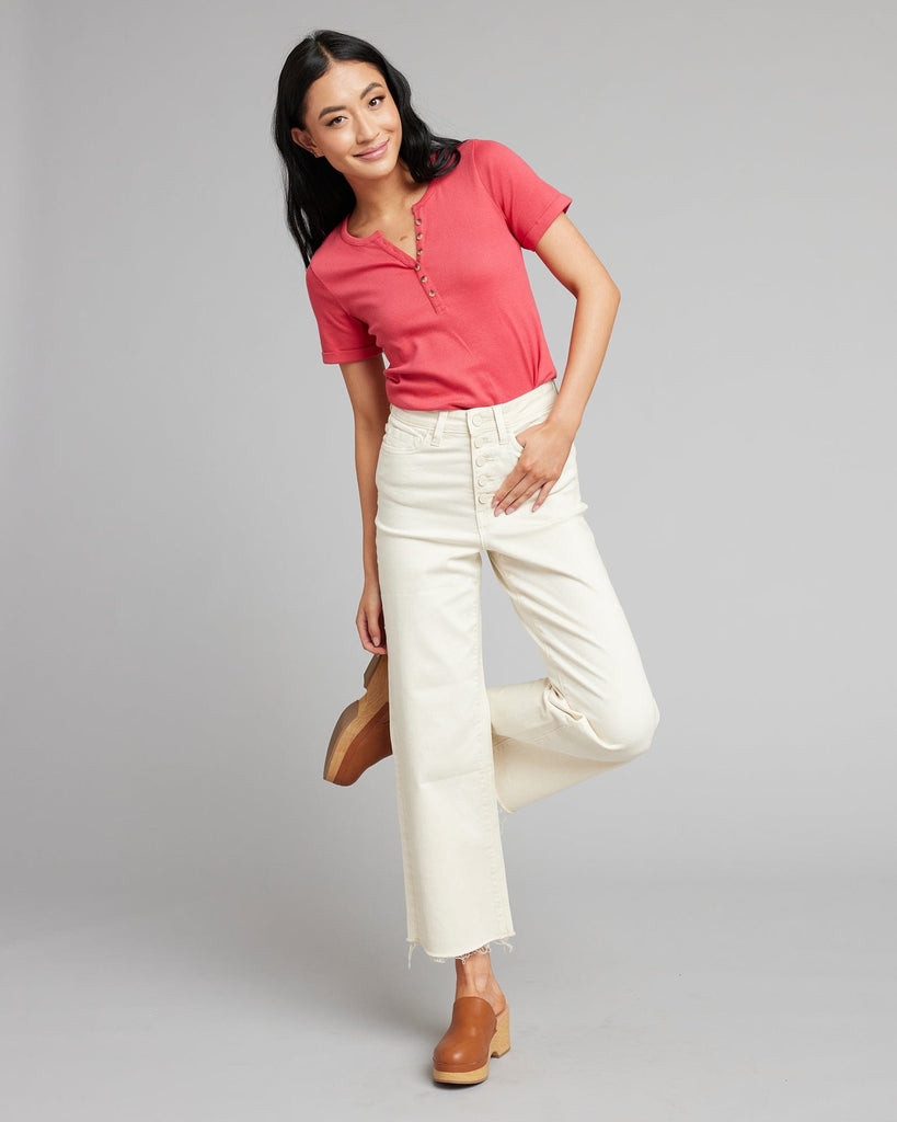 Woman in white high rise cropped denim pants.