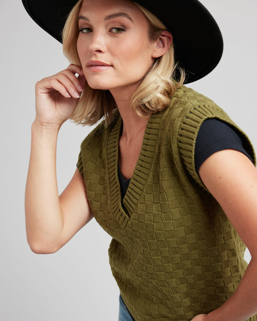 Woman in a textured knit pullover vest