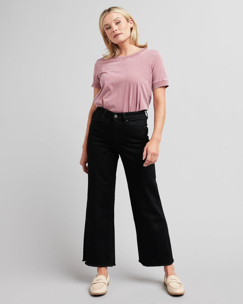 Woman in black wide-leg crop jeans