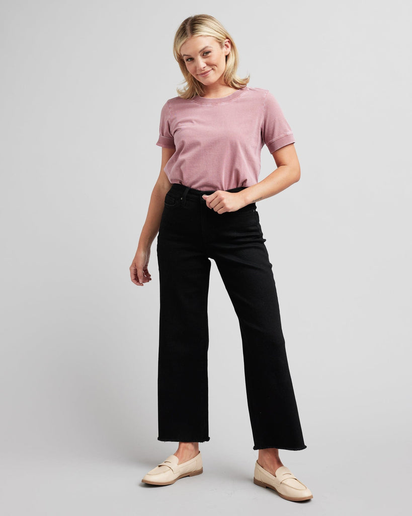 Woman in black wide-leg crop jeans