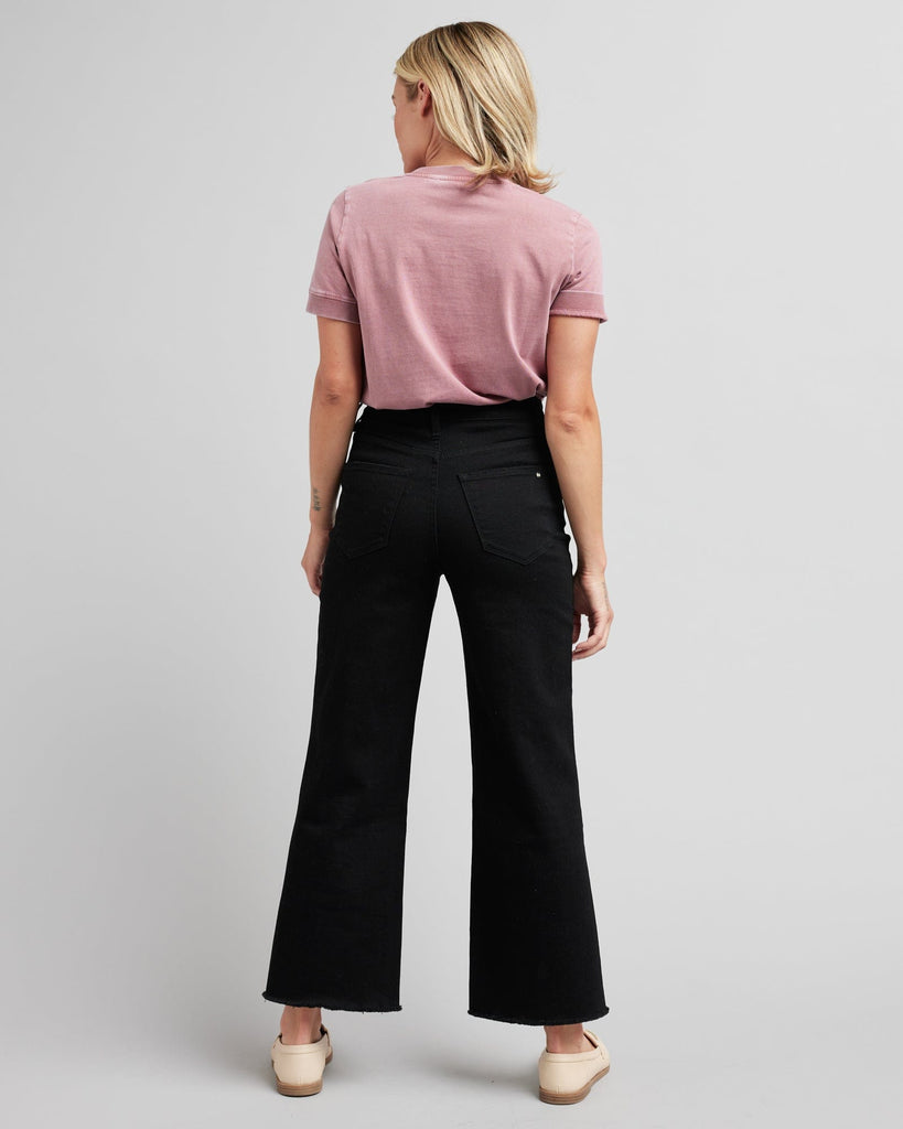 Woman in black wide-leg crop jeans