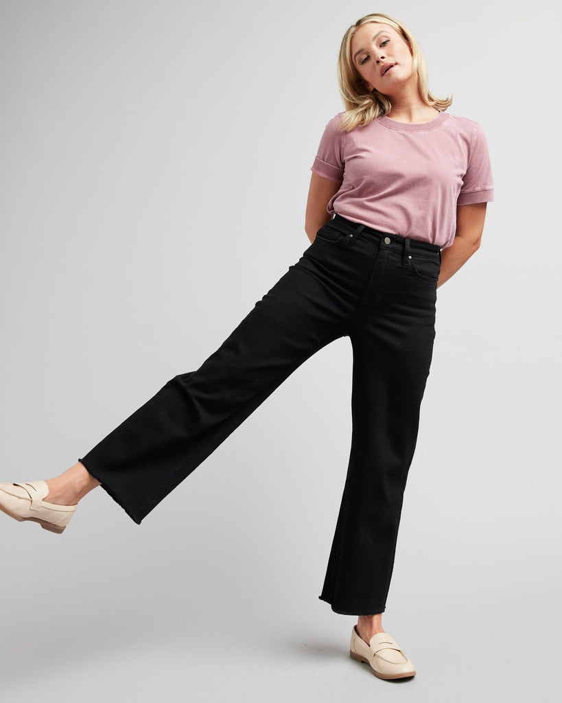 Woman in black wide-leg crop jeans