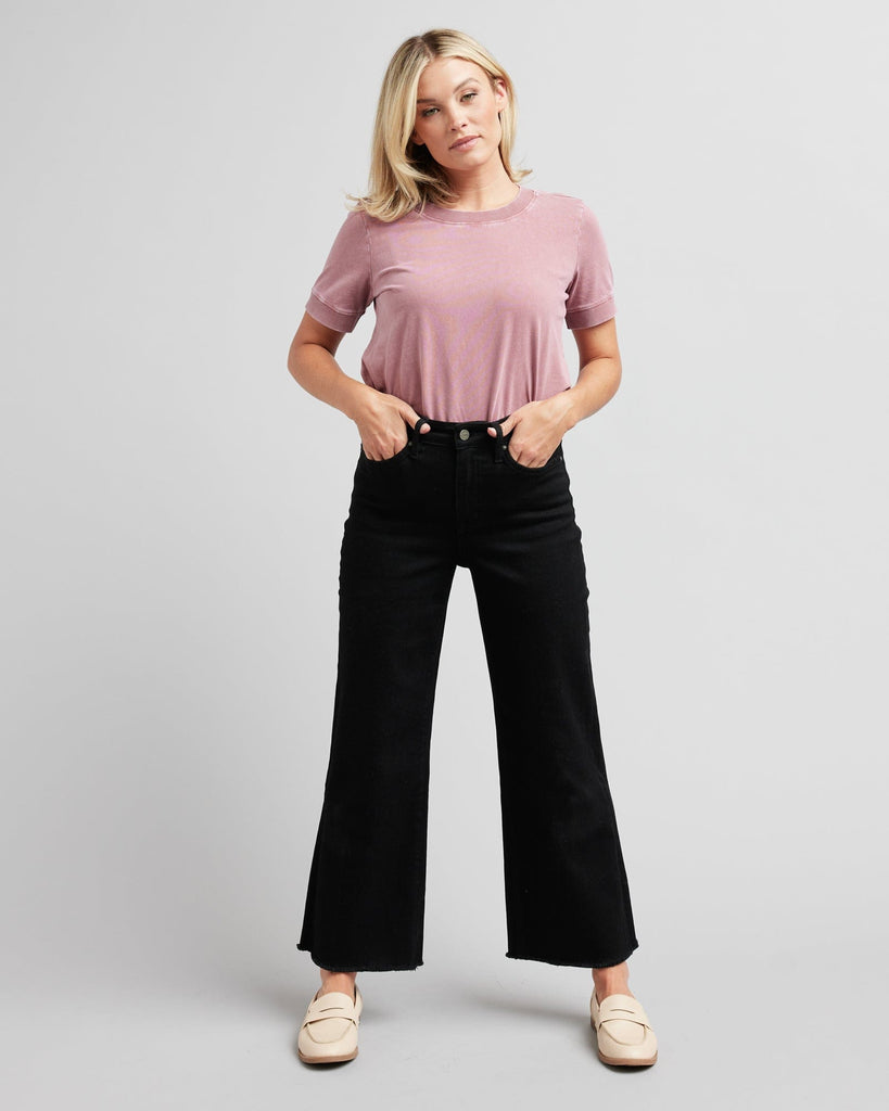 Woman in black wide-leg crop jeans