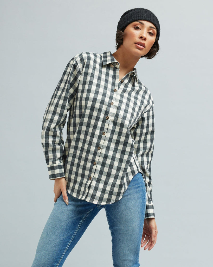 Woman in a long sleeve, black and white gingham, button-down blouse