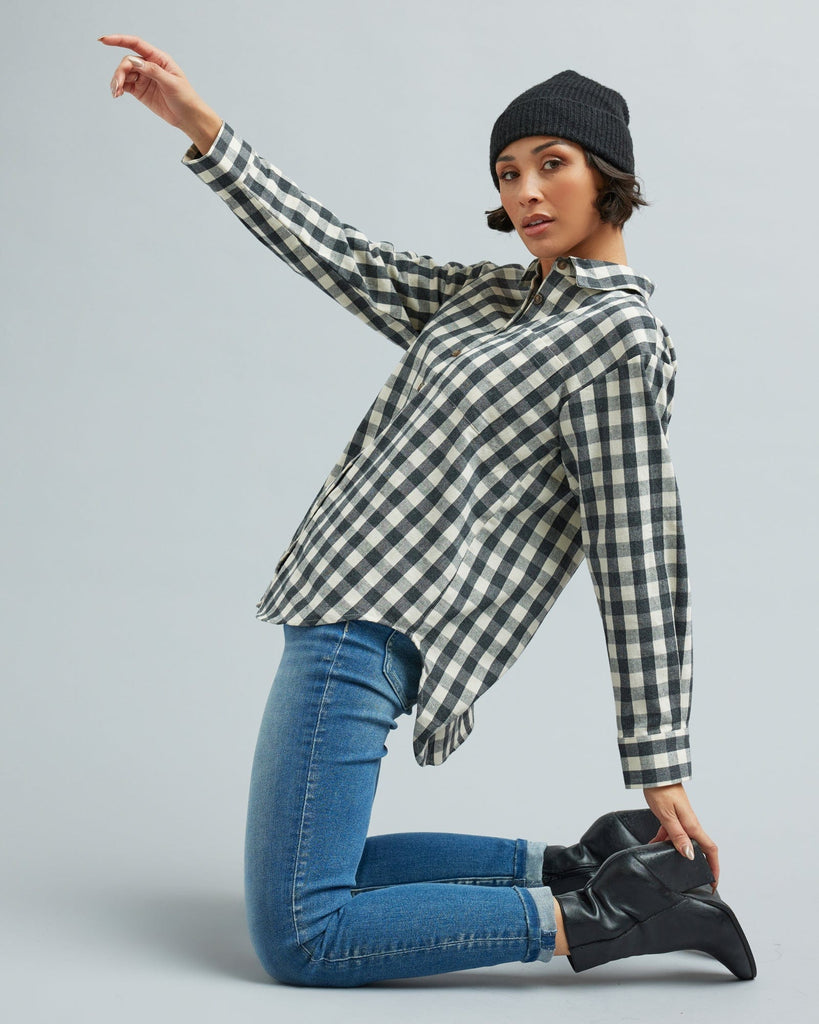 Woman in a long sleeve, black and white gingham, button-down blouse