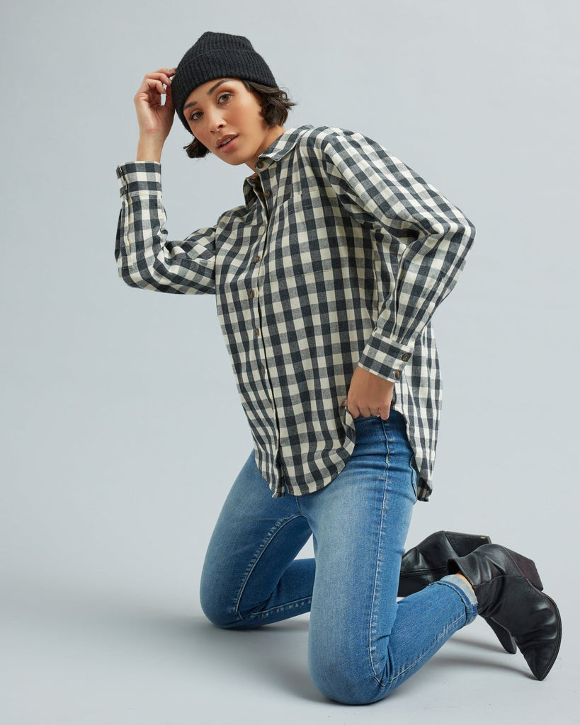 Woman in a long sleeve, black and white gingham, button-down blouse