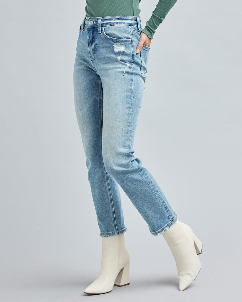 Woman in light blue jean, ankle length jean pants.