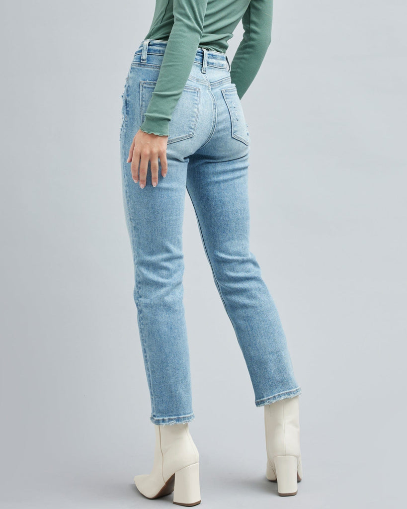 Woman in light blue jean, ankle length jean pants.