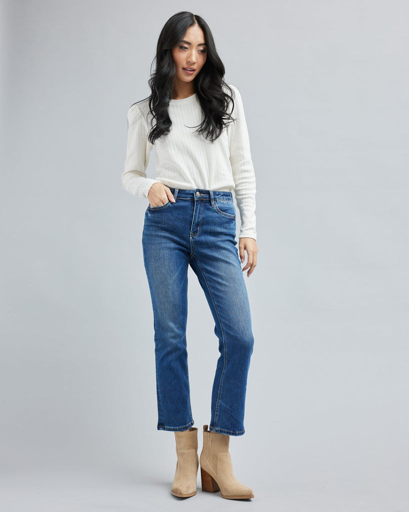 Woman in blue jean, ankle length denim pants.