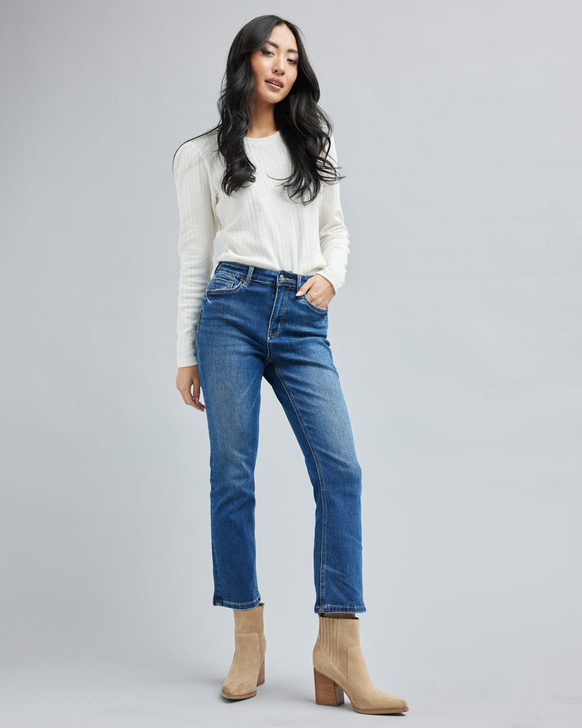 Woman in blue jean, ankle length denim pants.