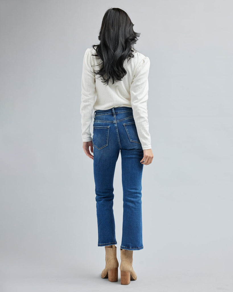 Woman in blue jean, ankle length denim pants.