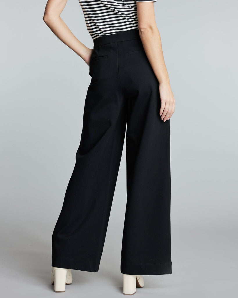 Woman in floor length black pants