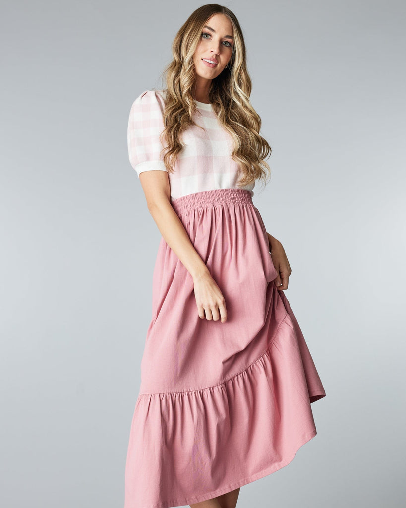 Woman in a pink, tiered, midi skirt