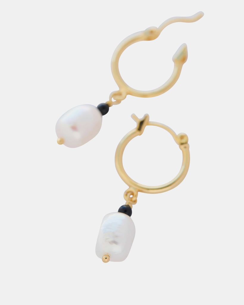 Gold hoop earrings with pearl bead. 