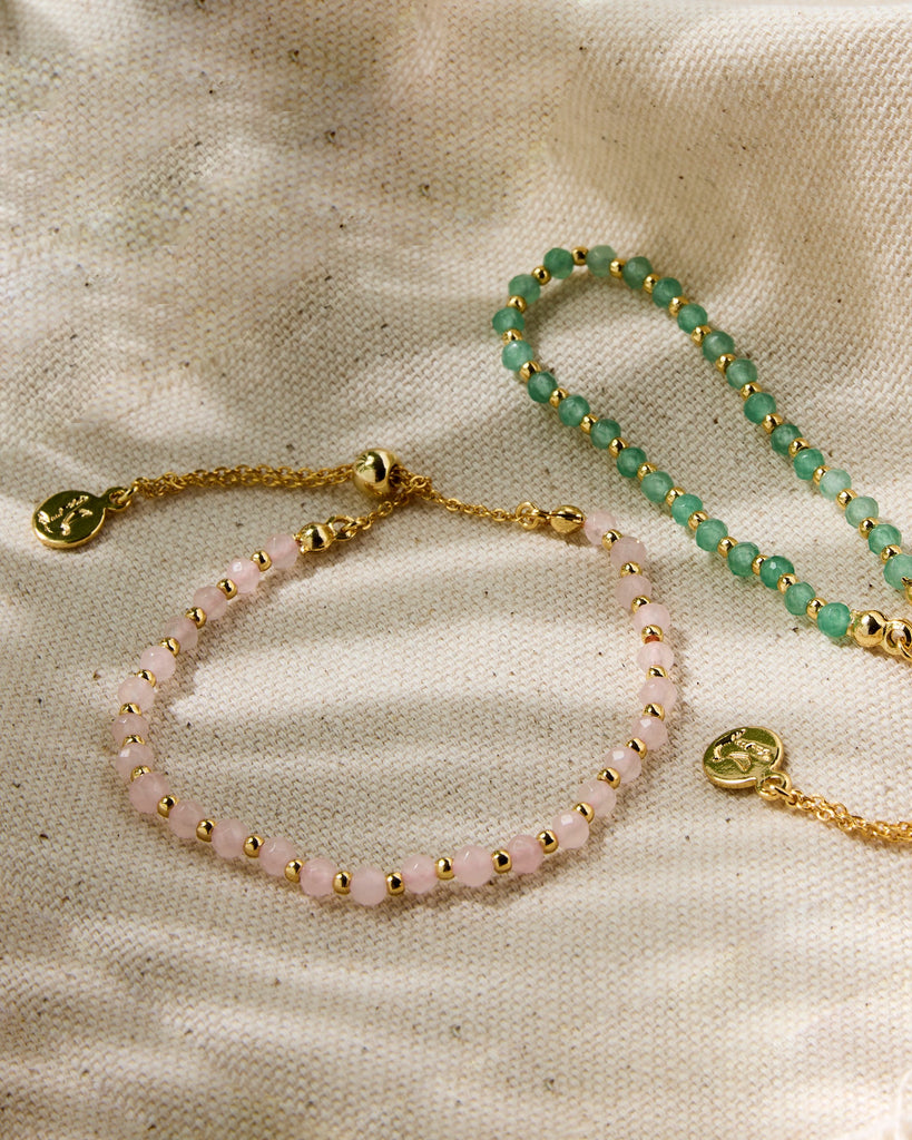 Set of two bracelets with gold chains and pink or green beads